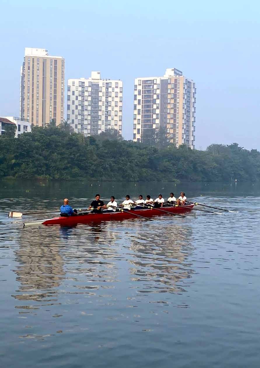 Program students and a coach rowing on the Adyar River in Chennai